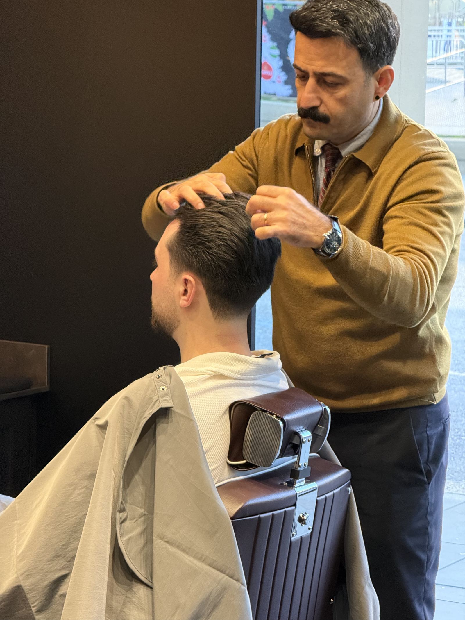 Barber applying hot towel treatment