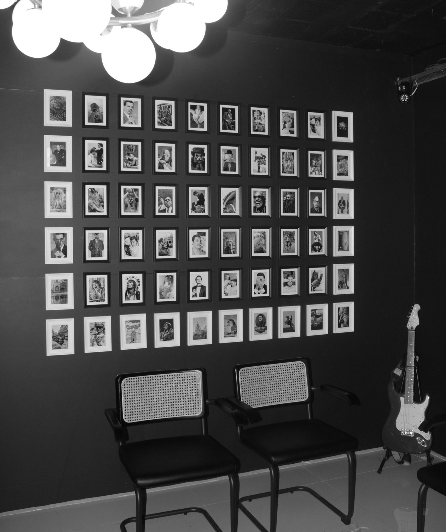 HAIRETRO waiting area with framed portrait wall